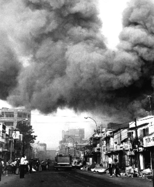 Black smoke covers areas of Saigon in 1968 as fire trucks rush to the scenes of fires set by the Viet Cong during the Tet holiday.